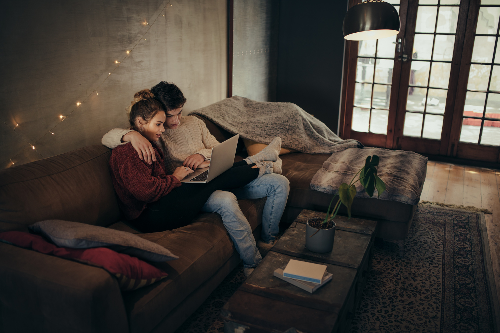 Couple Relaxing with a Laptop in Cozy Living Room